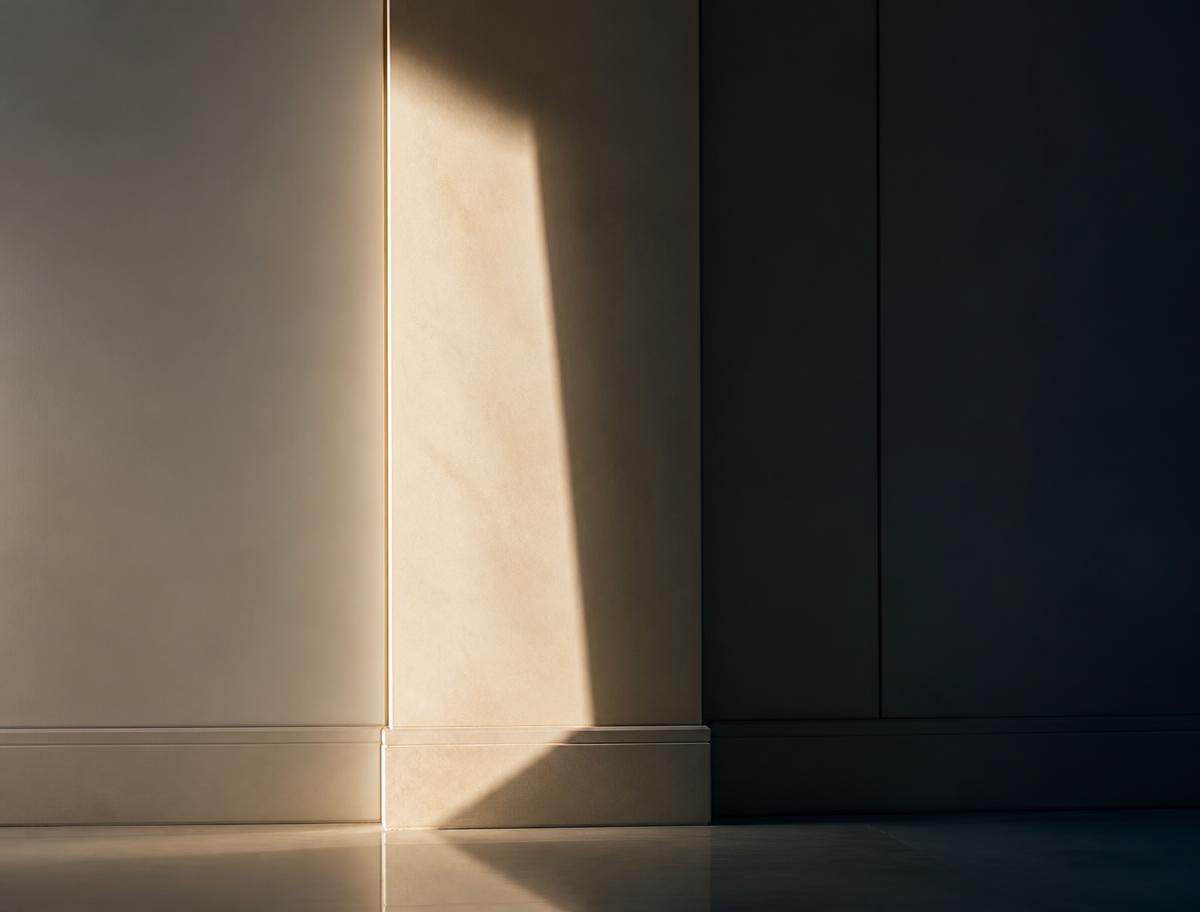 Quiet architectural interior with a narrow beam of warm light